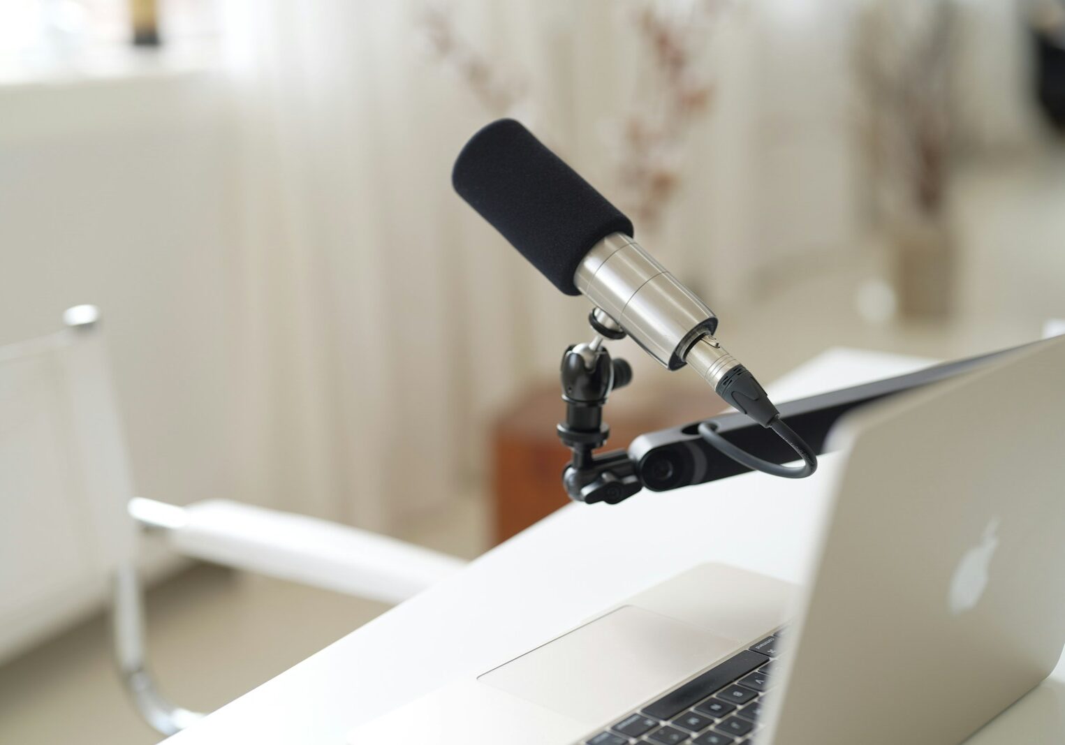 a microphone attached to a laptop computer on a desk